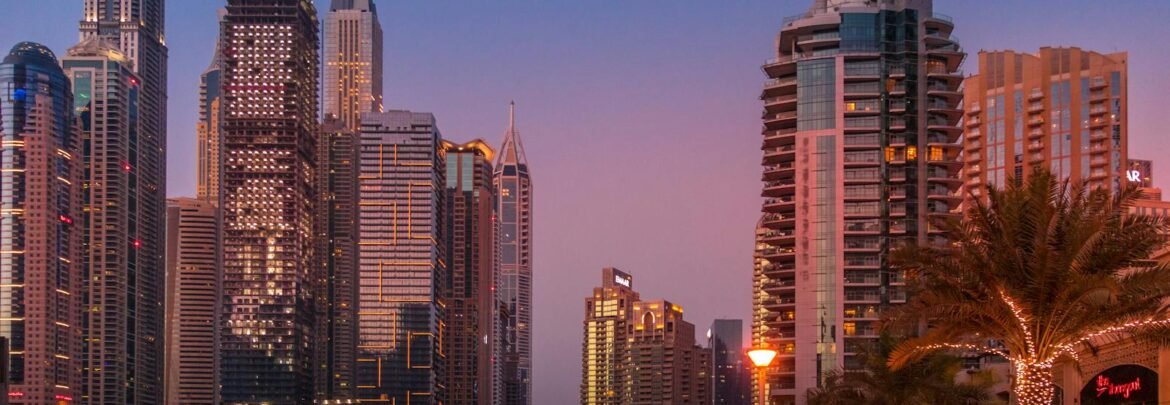A stunning view of the Dubai Marina skyline illuminated at sunset, showcasing urban city life.