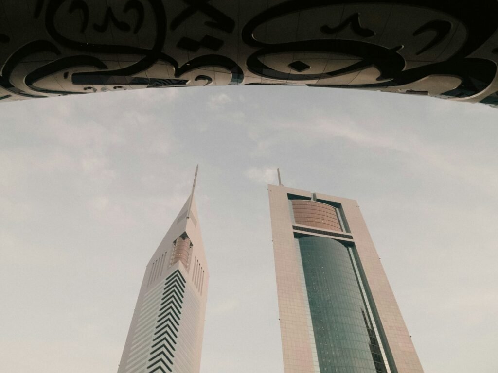 a couple of tall buildings sitting next to each other