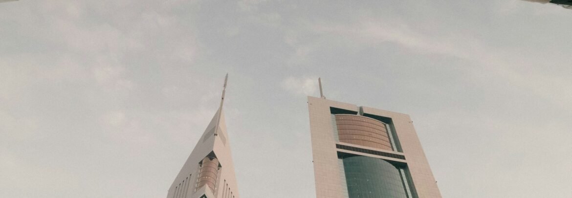 a couple of tall buildings sitting next to each other