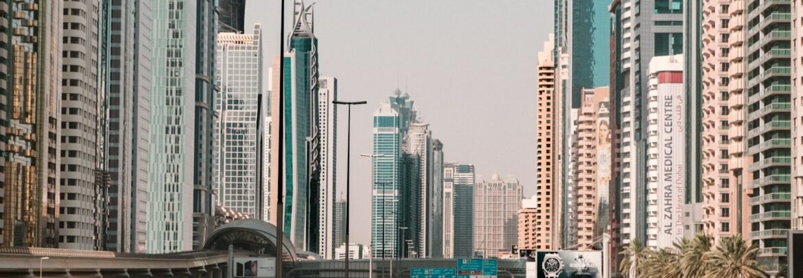 cars on road near high rise buildings during daytime