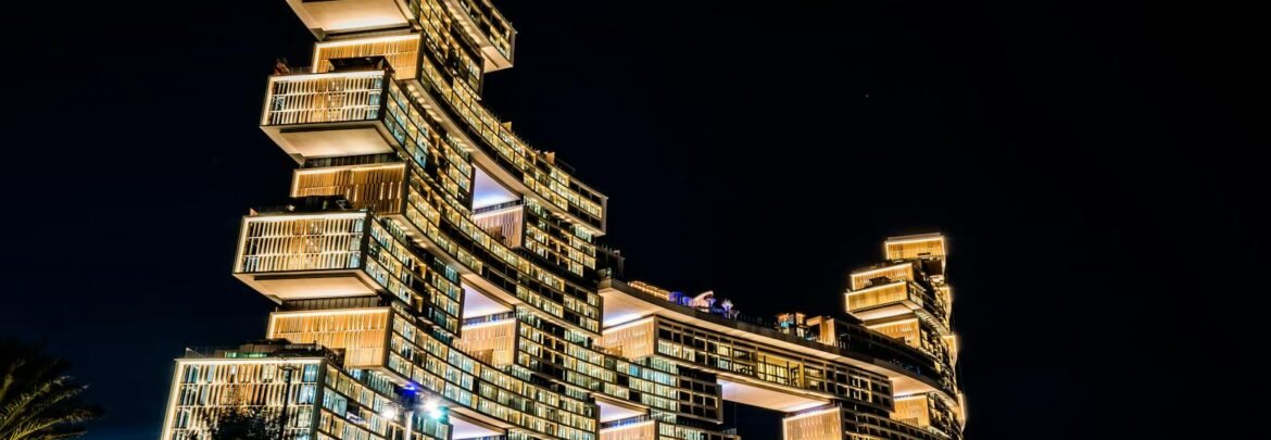 Stunning view of the illuminated Atlantis The Royal Hotel in Dubai, showcasing its modern architecture against the night sky.
