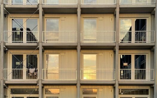 a tall building with multiple balconies and balconies