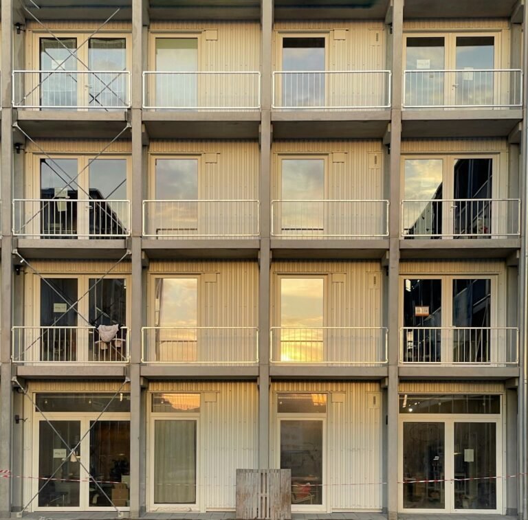 a tall building with multiple balconies and balconies