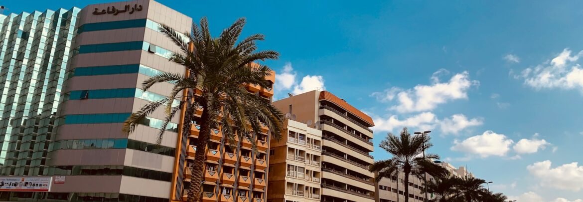 white and brown concrete building near green palm trees during daytime