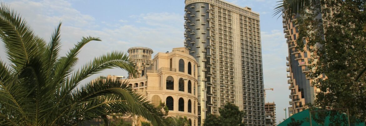 Modern buildings stand tall under a blue sky.