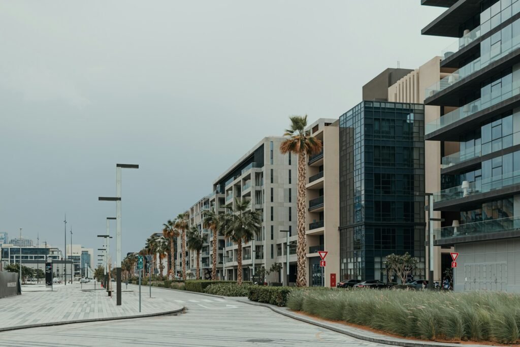 A city street with tall buildings and palm trees