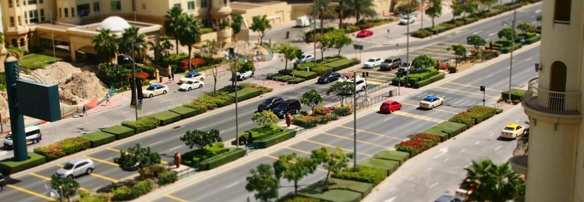 a city street filled with lots of traffic next to tall buildings