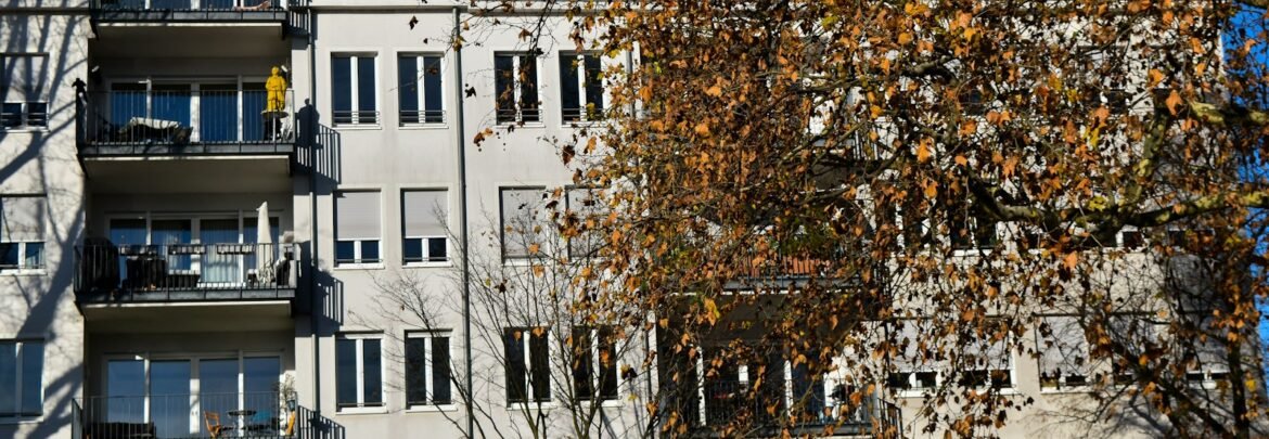 A tall white building with balconies and balconies
