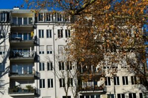 A tall white building with balconies and balconies
