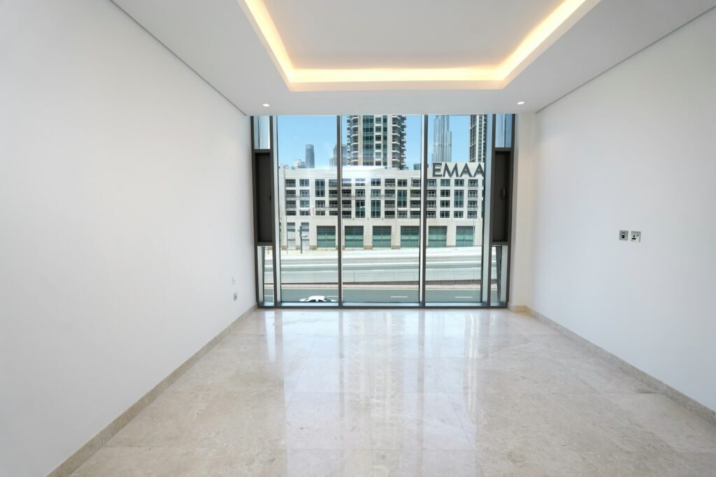 An empty room with a view of a city