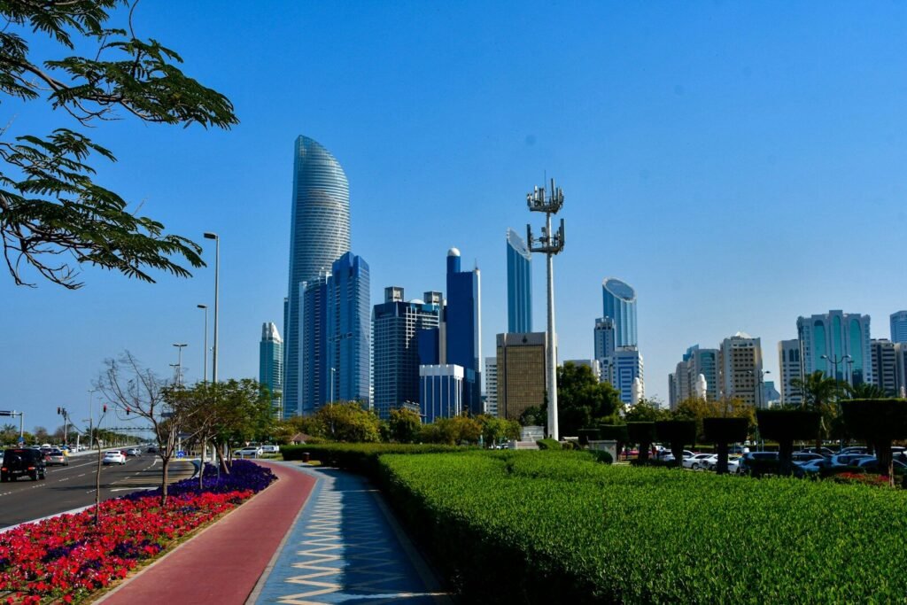 a city skyline with a sidewalk and cars