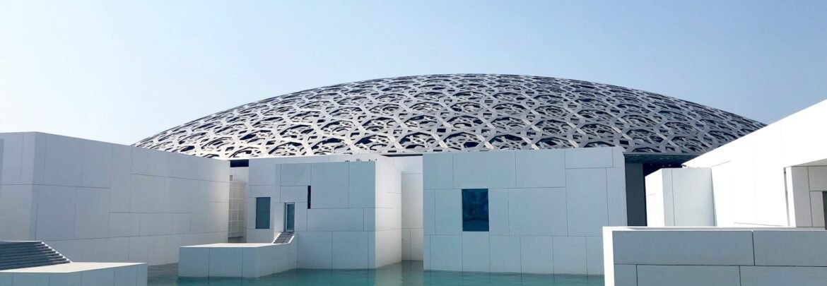 white concrete building near body of water during daytime