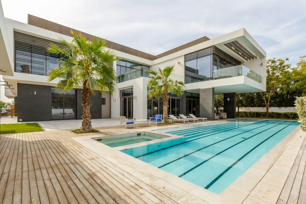 Explore this luxurious modern villa in Dubai with a stunning swimming pool and palm trees.