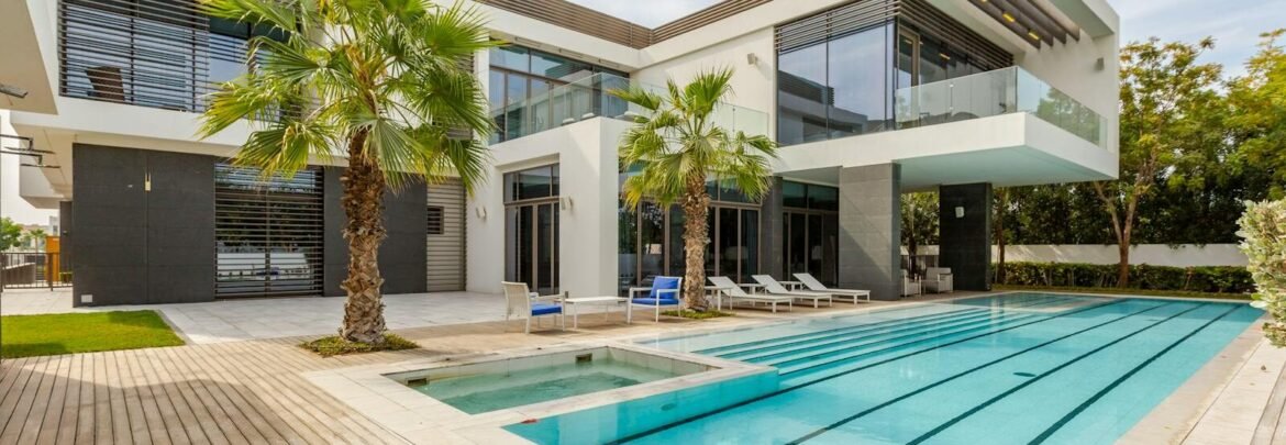 Explore this luxurious modern villa in Dubai with a stunning swimming pool and palm trees.