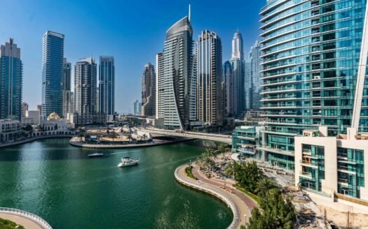 A river running through a city next to tall buildings