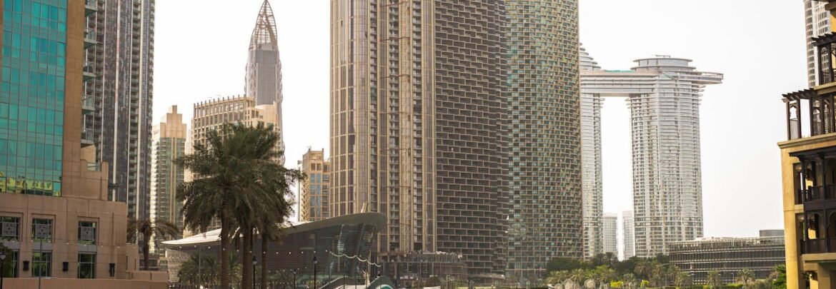 Stunning view of Dubai's modern skyline and vibrant blue water under a clear sky.