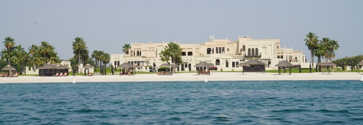 white concrete building near body of water during daytime