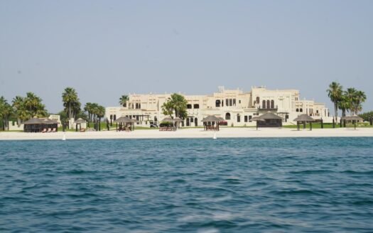 white concrete building near body of water during daytime