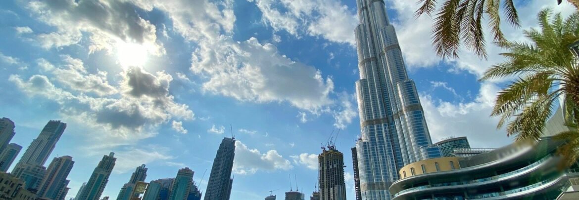 white and gray high rise buildings near body of water during daytime