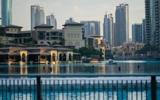 A body of water with buildings in the background