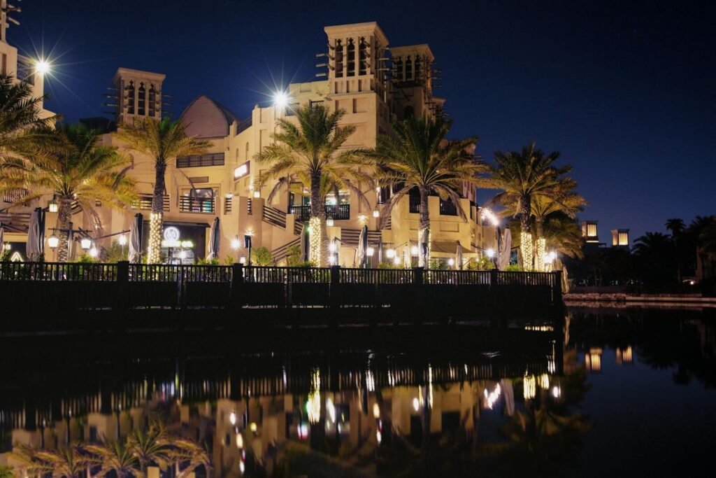 Elegant Dubai architecture reflected in a waterfront setting at night.