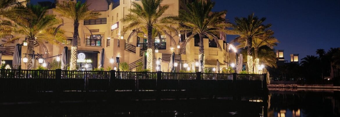 Elegant Dubai architecture reflected in a waterfront setting at night.