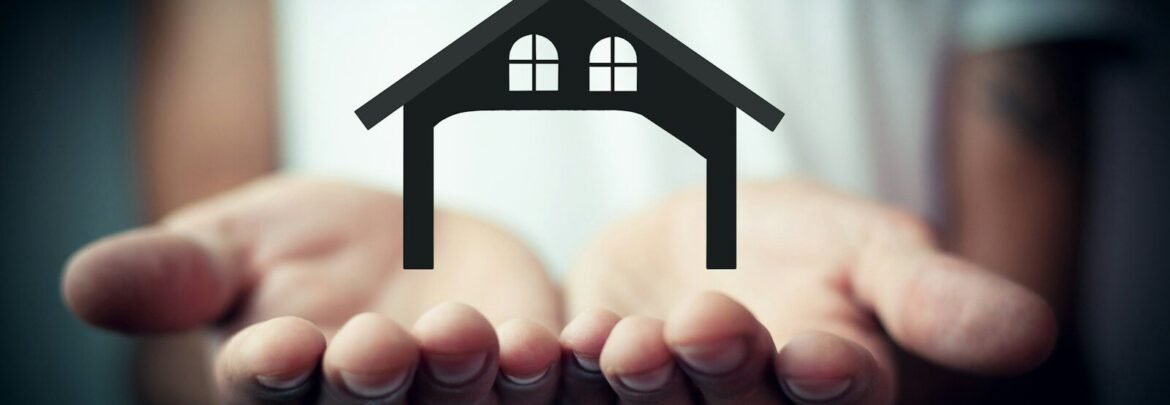 Hands holding a silhouette of a house