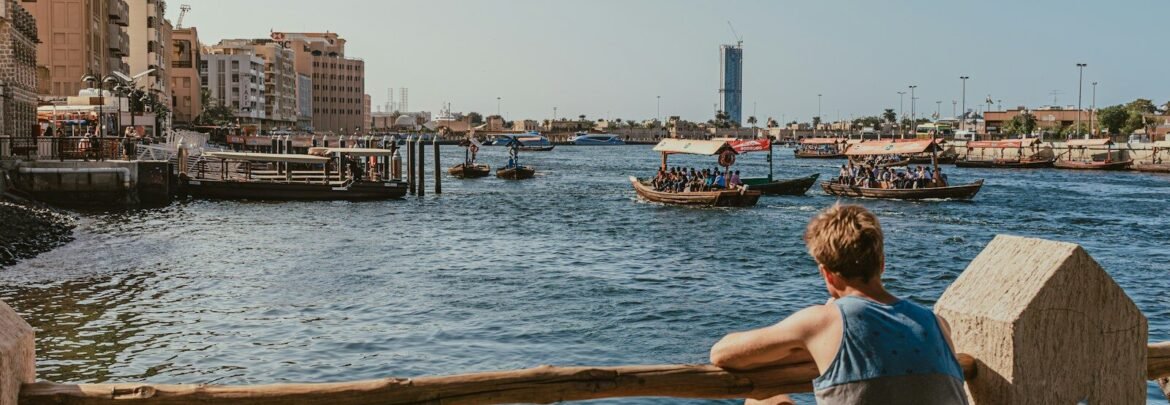 A man sitting at a table looking out over the water