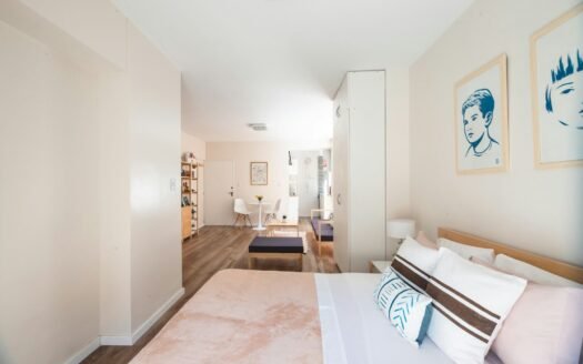 a bedroom with a bed and a couch